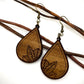 leaf engraved wood earrings hanging on a thin branch