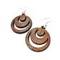 detail of round red wood earrings with moon holes