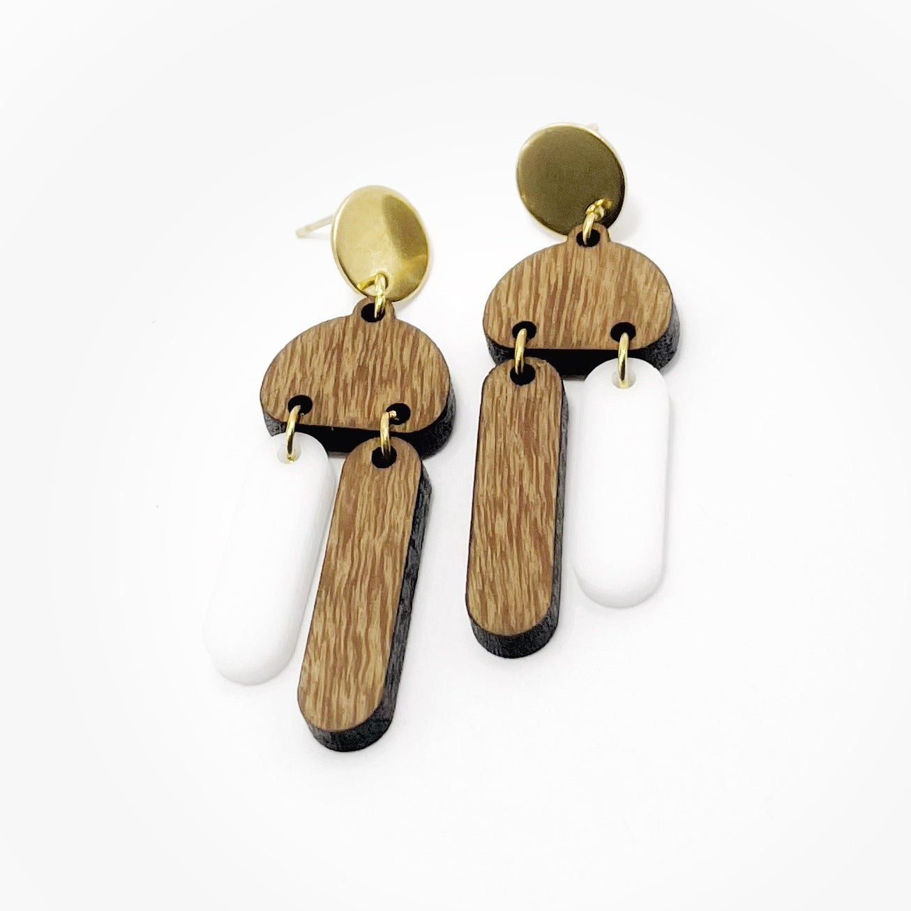 detailed shot of white and wood earrings